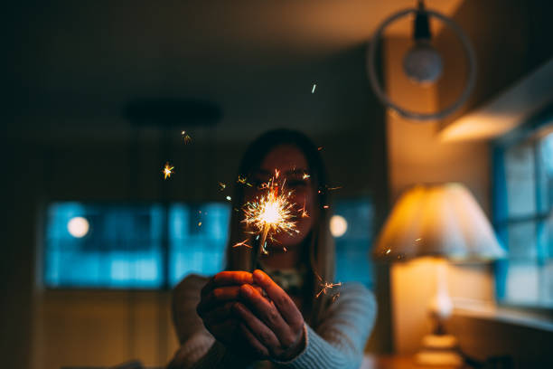 Young Woman Holding Sparkler
