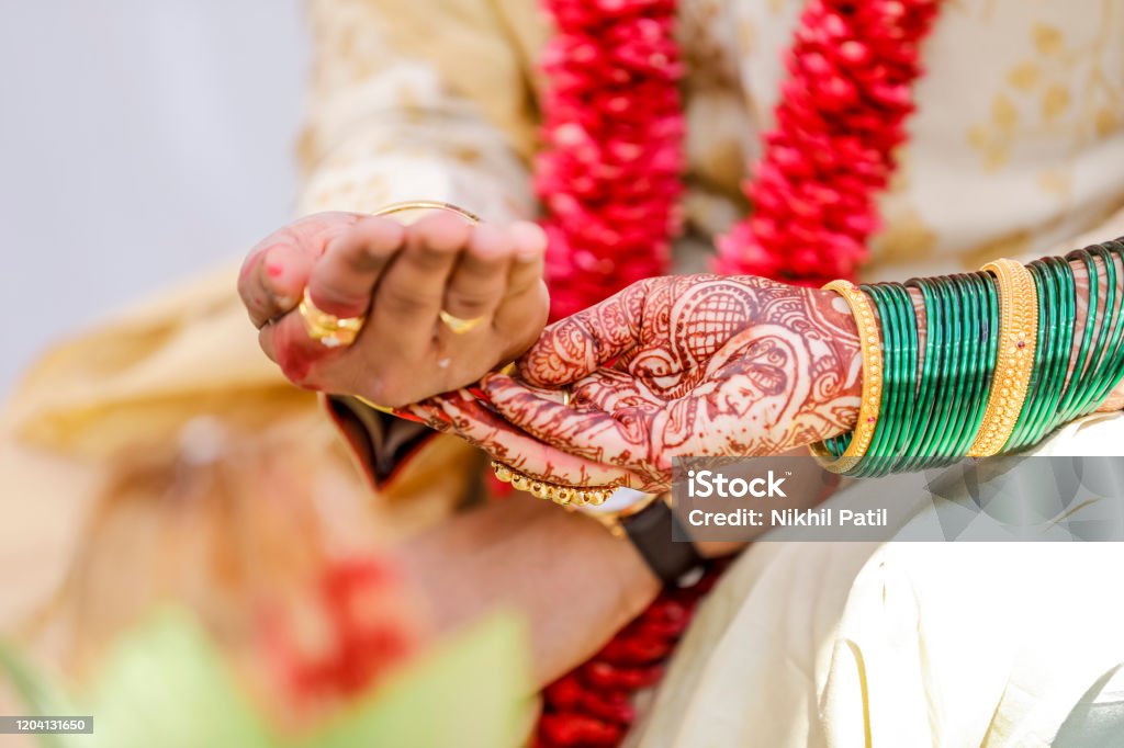 Traditional indian wedding ceremony, groom holding hand in bride hand Culture of India Stock Photo