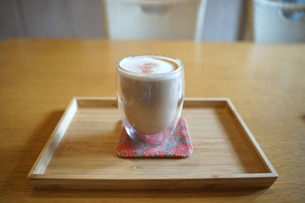 istock Close up hot coffee  latte in transparent glass on timber table 1204135686