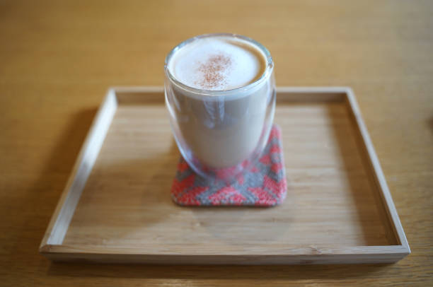 istock Close up hot coffee  latte in transparent glass on timber table 1204135712