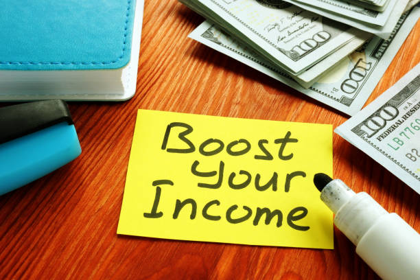 istock Boost Your Income financial motivation phrase and money. 1204136092