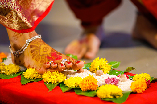 Indian wedding ceremony in Hinduism  : green leaf rice grain and marigold flower decorative on wooden board for bridal entry