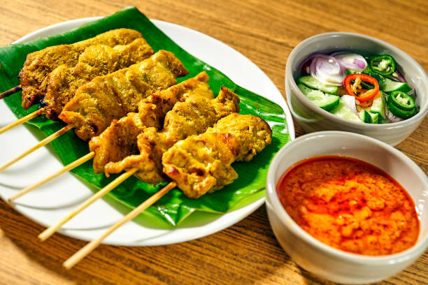 Grilled Pork Satay served with Spicy peanut sauce and atjar (pickle cucumber slices and onions in vinegar). Pork prepare with turmeric and other herbs will show unique yummy taste. The old recipe of Indonesian food in Thai style cooked that very famous in Thailand. You could find this food in restaurant and street food.