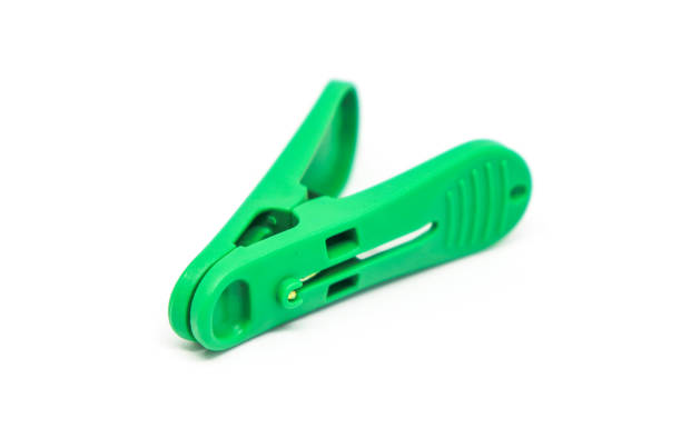 istock Green plastic clothespin isolated on white background. Plastic clips 1204142664