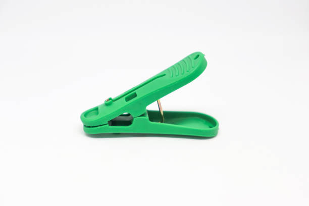 istock Green plastic clothespin isolated on white background. Plastic clips 1204142882