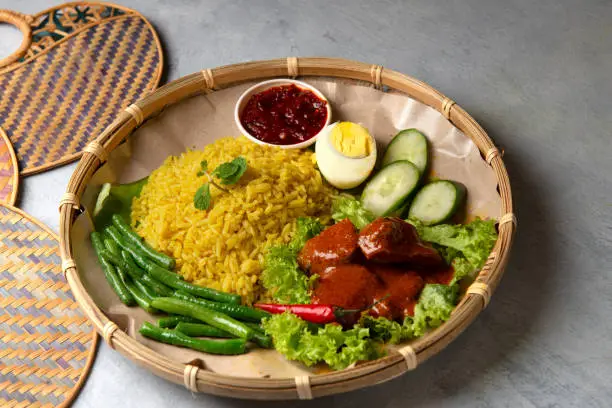 Photo of Turmeric rice with curry or nasi kunyit kuning, popular dish in malaysia