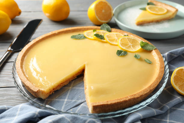 istock Composition with lemon tart on grey wooden background, close up 1204147206