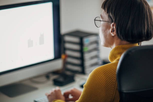 istock Young woman with eyeglasses in the office working on the computer 1204147497