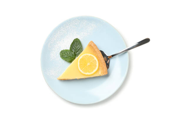 istock Plate with lemon tart slice and mint isolated on white background 1204147802