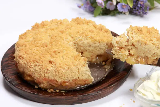 Freshly made Apple Crumble or Pie on wooden platter
