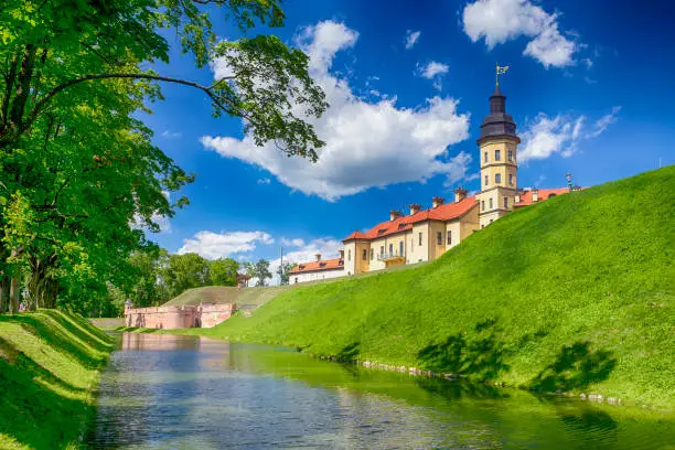 Photo of Famous Tourist Destinations.Backside of  Renowned Nesvizh Castle on The Moat as a Profound Example of Medieval Ages Heritage and Residence of the Radziwill Family.Horizontal Image