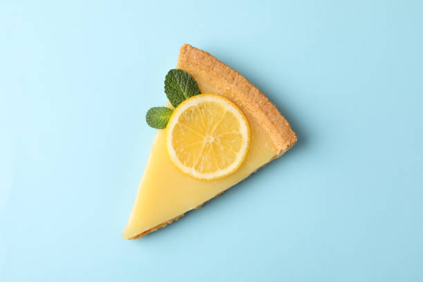 istock Lemon tart slice on blue background, top view 1204149371