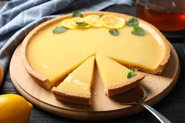 istock Composition with lemon tart on dark wooden background, close up 1204149445