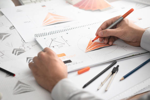 istock Graphic designer drawing sketches logo design. 1204149690