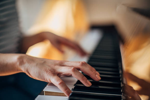 istock Woman pianist playing piano 1204150390