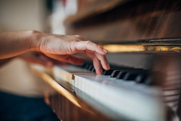 istock Woman pianist playing piano 1204150432