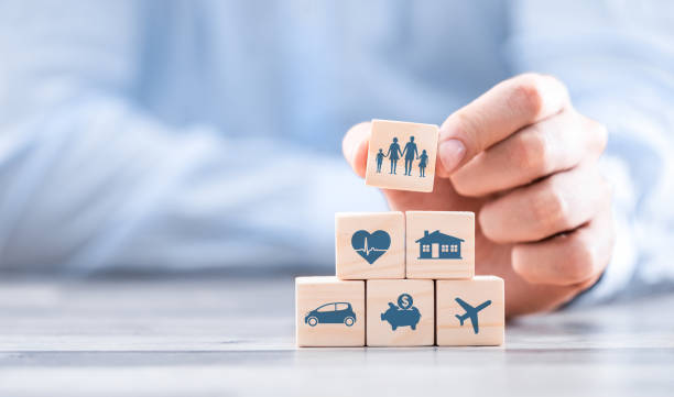 Life insurance concept. Wooden blocks with icons of various types of insurance. Life insurance concept. wealthy stock pictures, royalty-free photos & images