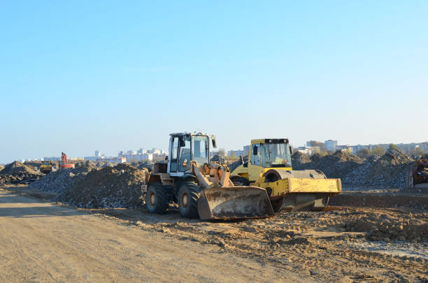 istock Soil Compactor and wheel loader at construction site. Vibration single-cylinder road roller 1204150727