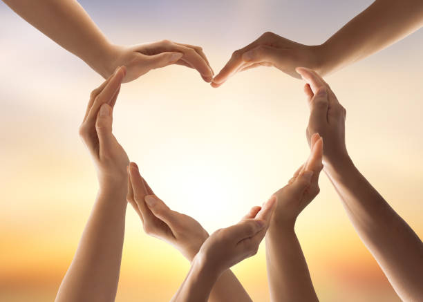 The concept of unity, cooperation, teamwork and charity. Symbol and shape of heart created from hands.The concept of unity, cooperation, partnership, teamwork and charity. diversity hands forming heart stock pictures, royalty-free photos & images