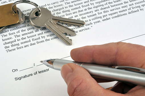 close-up on signing a document in English from a lessor