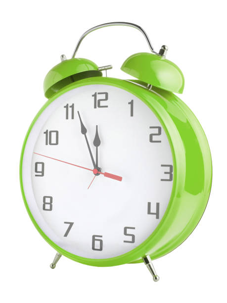 istock Old style green alarm clock isolated on white background 1204152329