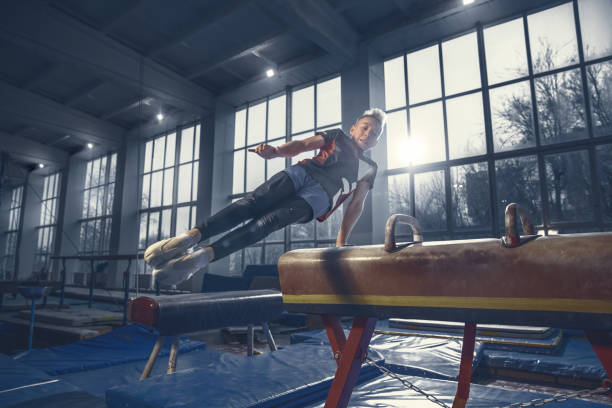 istock Little male gymnast training in gym, flexible and active 1204152429