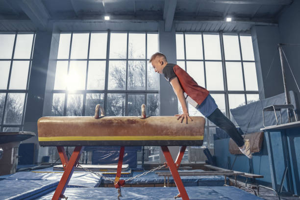 istock Little male gymnast training in gym, flexible and active 1204152433