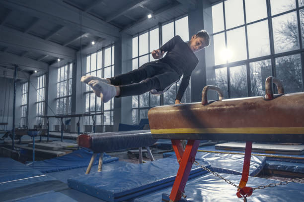 istock Little male gymnast training in gym, flexible and active 1204152438