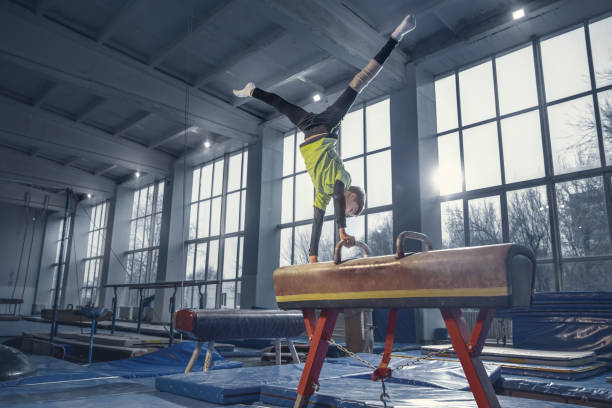 istock Little male gymnast training in gym, flexible and active 1204152489
