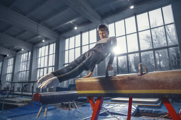 istock Little male gymnast training in gym, flexible and active 1204152492