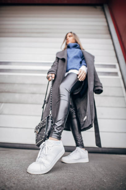 istock Young fashion model posing in front of building 1204152602