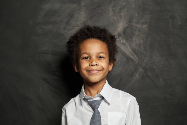 istock Happy black kid boy. Cute child on blackboard background portrait 1204152603