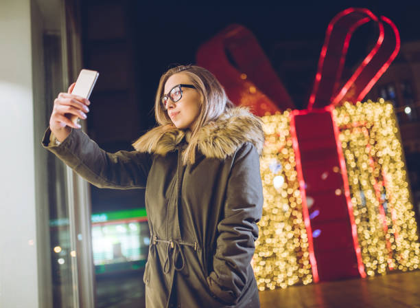 istock Woman making selfies downtown at night 1204153890