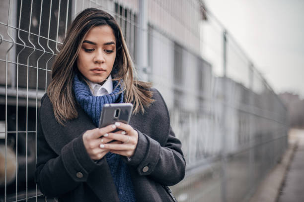 istock Woman on the street using smart phone 1204153961
