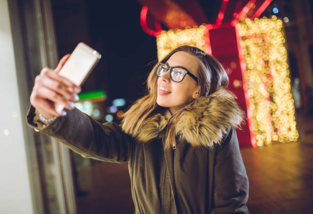 istock Woman making selfies downtown at night 1204153962