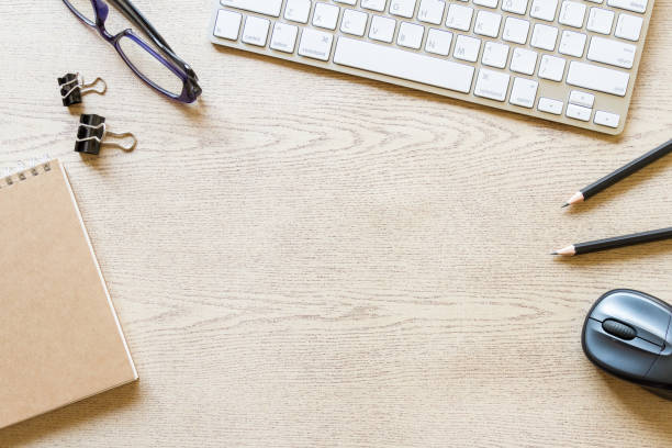 istock top view wooden office desk with computer and supplies 1204155668