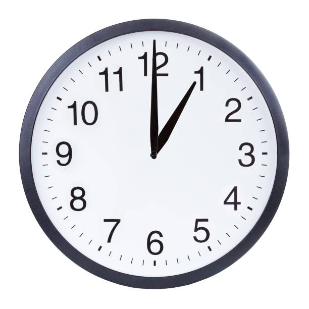istock Round office clock showing one o'clock isolated on white background 1204156114