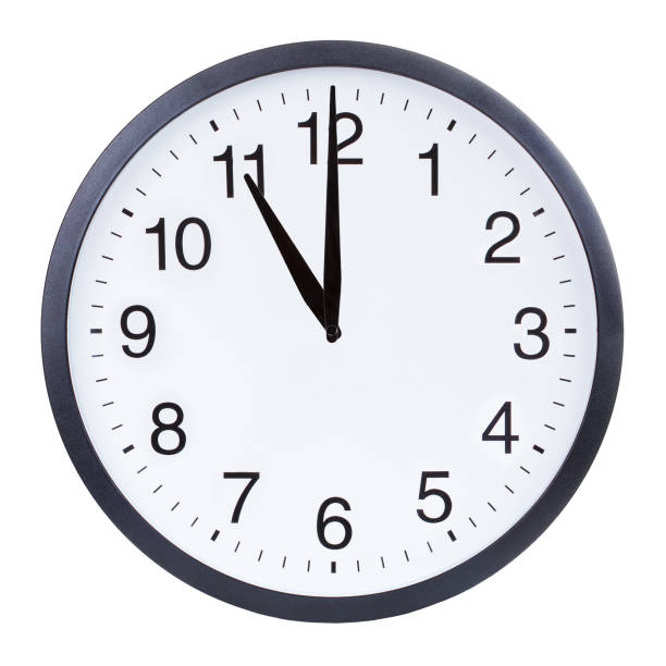 istock Round office clock showing eleven o'clock isolated on white background 1204156142