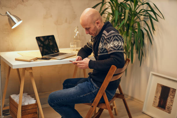 istock Young attractive Caucasian freelancer sitting at his home office and working. 1204156988