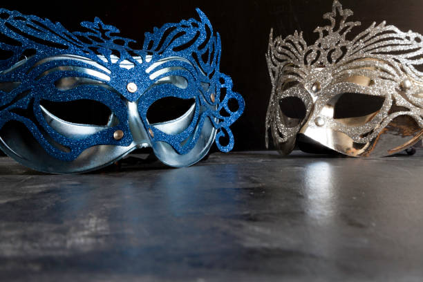 istock blue and silvery carnival masks on dark 1204159381