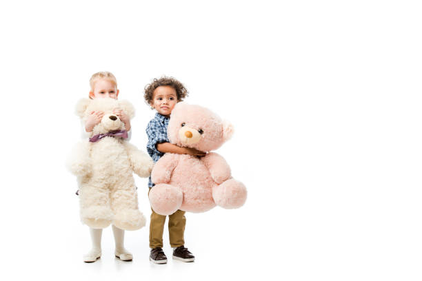 Portrait of an adorable brother and sister playing with their teddy bears at home