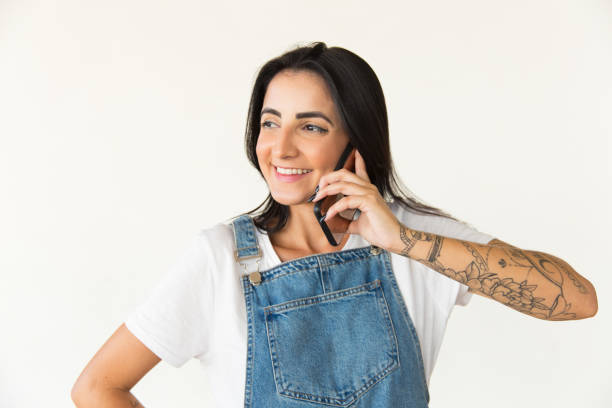 istock Happy young woman talking by cell phone 1204159450