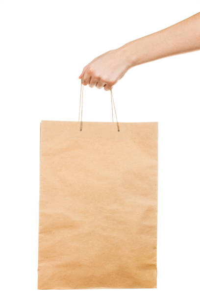 istock Female hand with kraft bag isolated on white background 1204160168