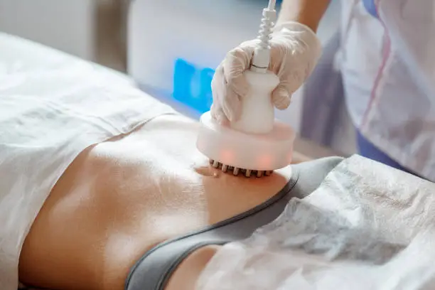 Photo of Hardware cosmetology. Picture of happy young woman with closed eyes getting rf lifting procedure in a beauty parlour