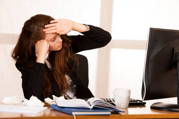istock il woman suffering at work behind the desk in her office 1204160363