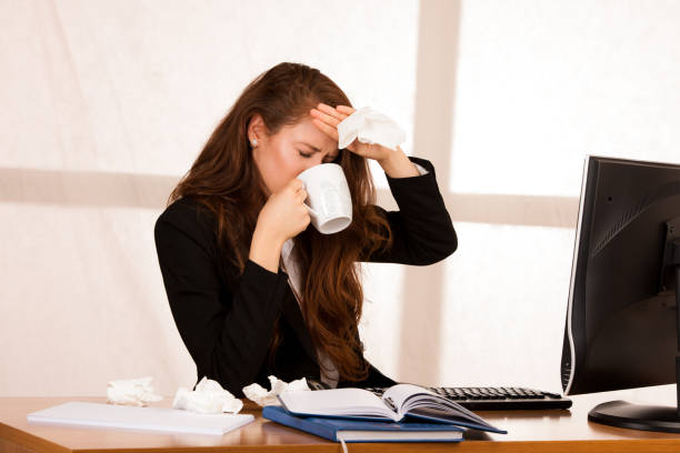 istock il woman suffering at work behind the desk in her office 1204160366