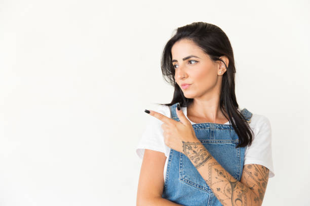 istock Attractive young woman pointing with finger 1204160449