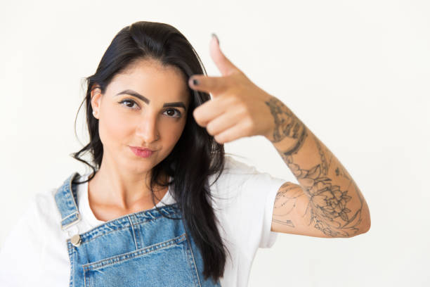 istock Confident brunette woman pointing at camera 1204160738