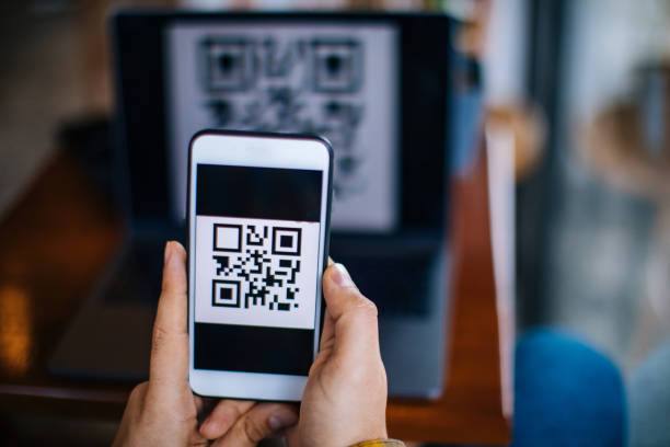 istock Scanning QR code forn laptop using mobile smartphone 1204162492