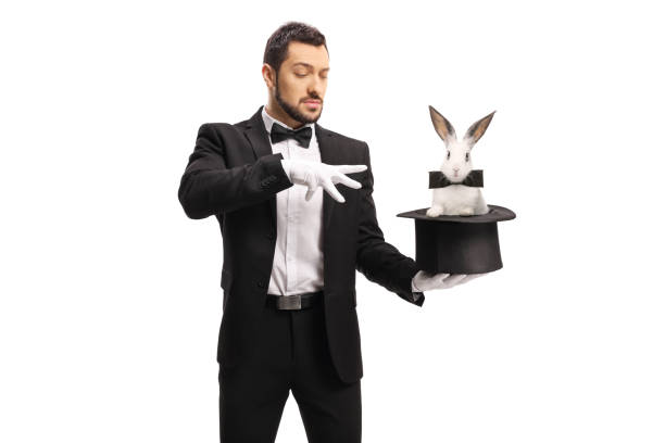 istock Young male magician making a magic trick with a rabbit in a top hat 1204162664